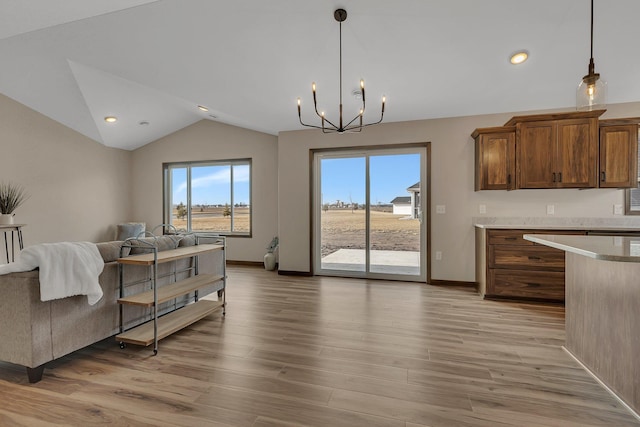 interior space featuring baseboards, light wood-style floors, an inviting chandelier, and vaulted ceiling