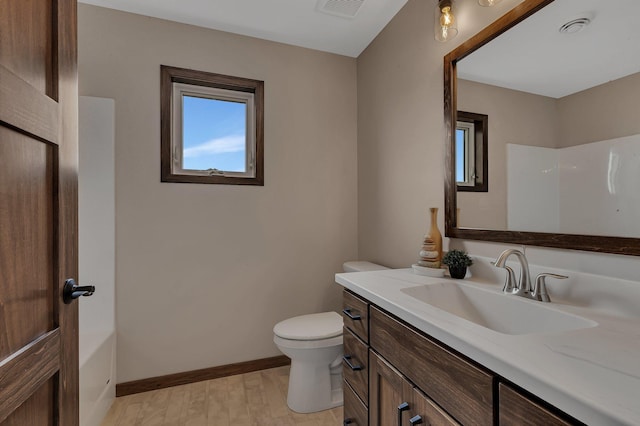 full bath with visible vents, toilet, wood finished floors, baseboards, and vanity