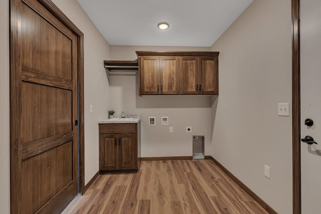 washroom with baseboards, hookup for a washing machine, light wood-style flooring, hookup for an electric dryer, and a sink