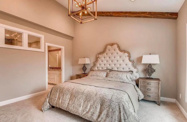 carpeted bedroom featuring connected bathroom, baseboards, and a notable chandelier