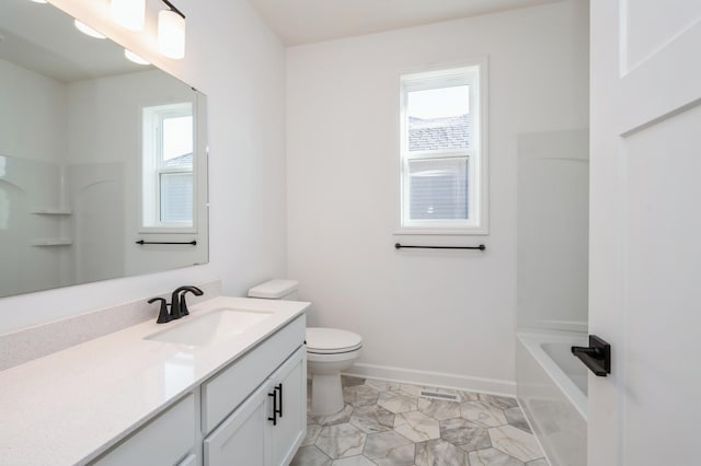 full bathroom with toilet, vanity, and baseboards