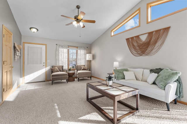 living area featuring baseboards, light colored carpet, light tile patterned flooring, high vaulted ceiling, and a ceiling fan