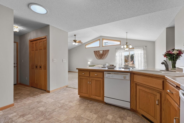 kitchen with ceiling fan with notable chandelier, a sink, brown cabinetry, white dishwasher, and lofted ceiling