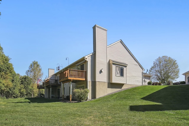 view of property exterior featuring a chimney, a deck, and a lawn