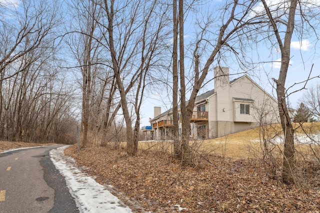 view of side of home featuring a chimney