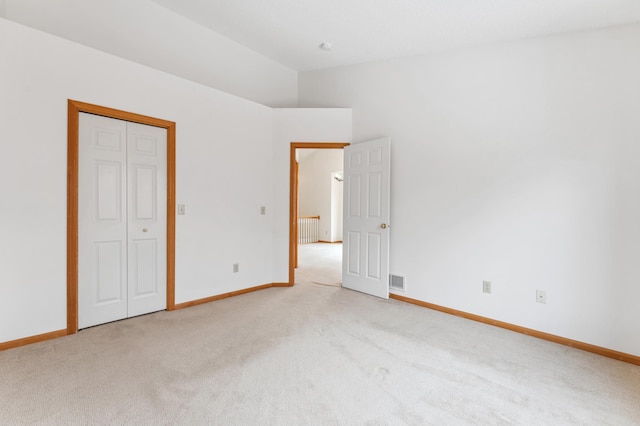 unfurnished bedroom with radiator, visible vents, baseboards, and light colored carpet