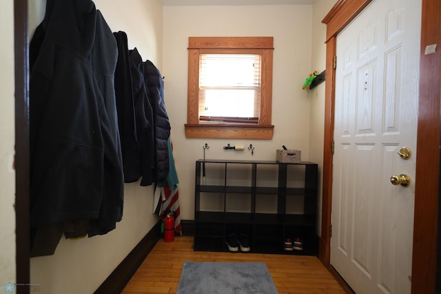 mudroom featuring light wood-style flooring and baseboards