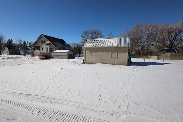 yard layered in snow with a garage and fence