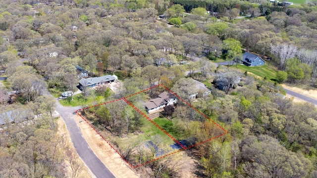 aerial overview of property's location featuring property parcel outlined and a forest