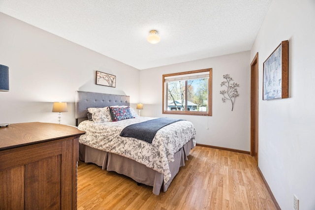 bedroom featuring light wood-style floors and baseboards