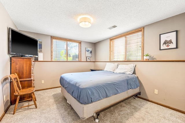 bedroom featuring carpet, a textured ceiling, and baseboards