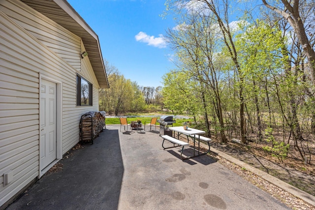 view of patio / terrace featuring an outdoor fire pit and grilling area