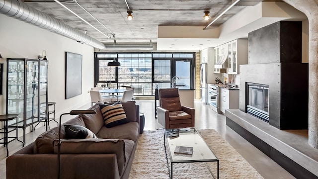 living area with concrete floors and a tile fireplace