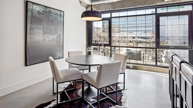 dining area featuring concrete floors