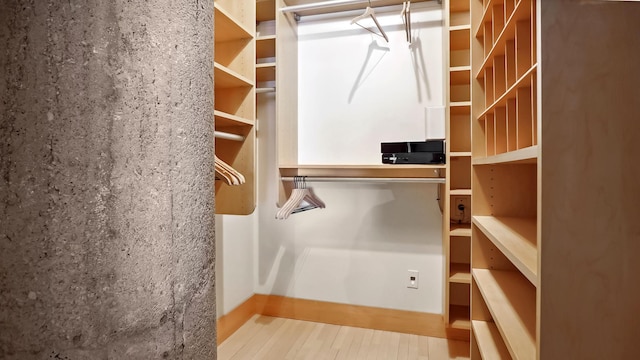 walk in closet featuring wood finished floors