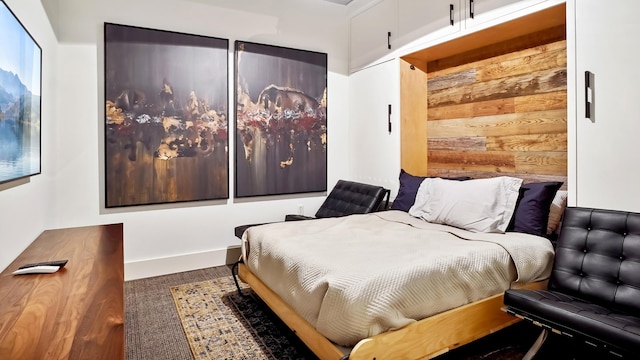 bedroom with wood walls