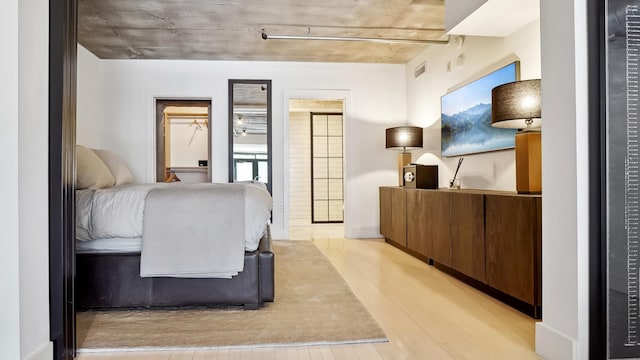 bedroom featuring visible vents and light wood-style floors