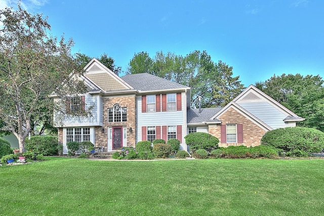 view of front of home with brick siding and a front lawn