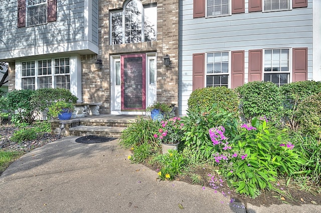 property entrance featuring brick siding