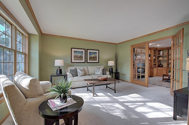 living room featuring light carpet, baseboards, ornamental molding, and french doors