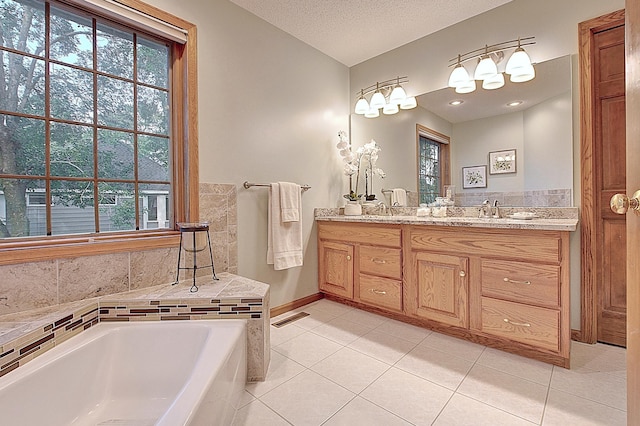 full bathroom featuring double vanity, tile patterned flooring, a garden tub, and visible vents