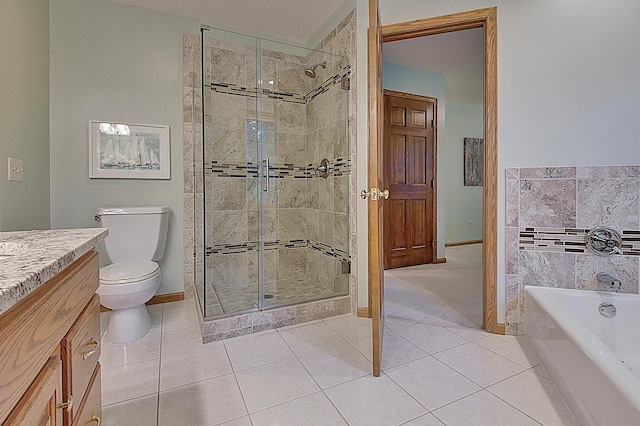 bathroom with a garden tub, toilet, a stall shower, vanity, and tile patterned floors