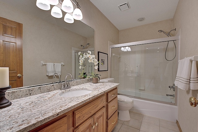 full bathroom featuring tile patterned flooring, toilet, vanity, visible vents, and combined bath / shower with glass door