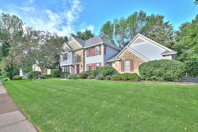 view of front of property with brick siding and a front lawn