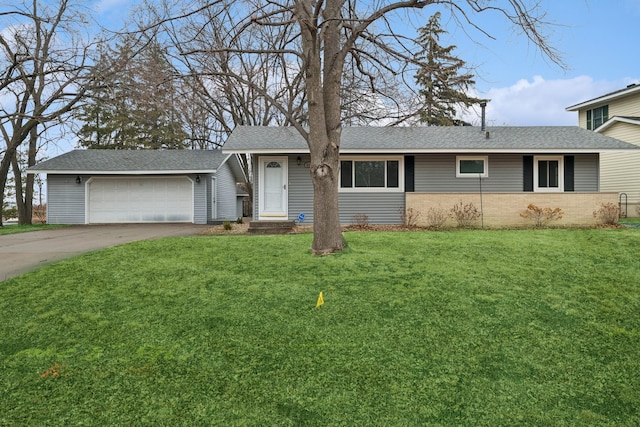 ranch-style house featuring a garage, concrete driveway, roof with shingles, a front yard, and brick siding