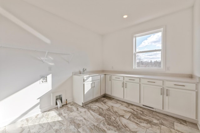 laundry area featuring recessed lighting, a sink, visible vents, marble finish floor, and cabinet space