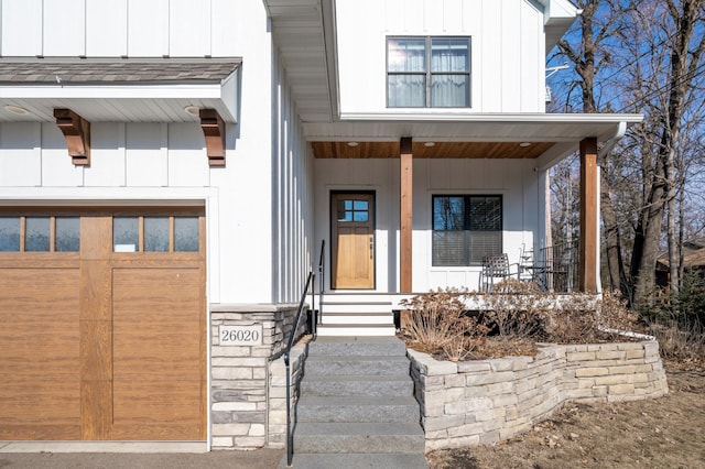 view of front of home featuring board and batten siding, covered porch, and a garage