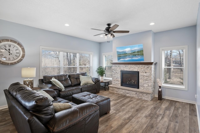 living room with a fireplace, baseboards, wood finished floors, and recessed lighting