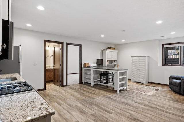 kitchen featuring open shelves, light wood-type flooring, white cabinetry, and recessed lighting