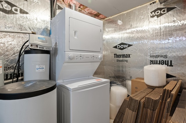 laundry area featuring stacked washer and clothes dryer and laundry area