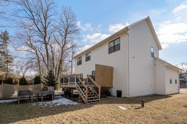 rear view of house featuring stairs and a deck