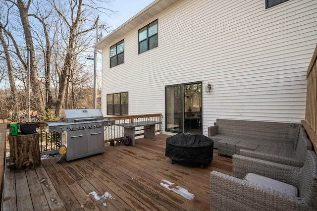 wooden terrace featuring outdoor lounge area and a grill