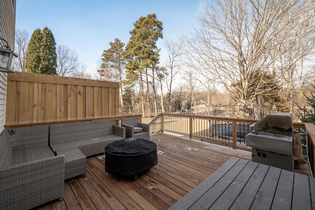 wooden deck with a grill and an outdoor living space