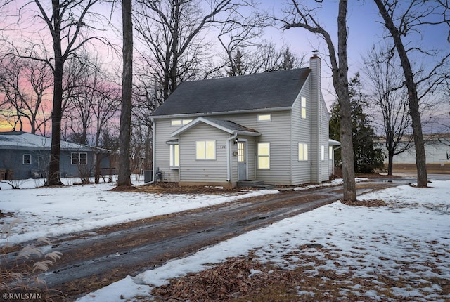 view of front facade featuring a chimney