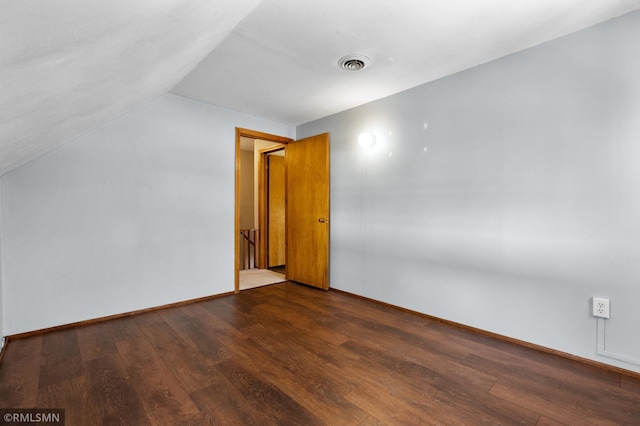 bonus room with baseboards, visible vents, vaulted ceiling, and wood finished floors