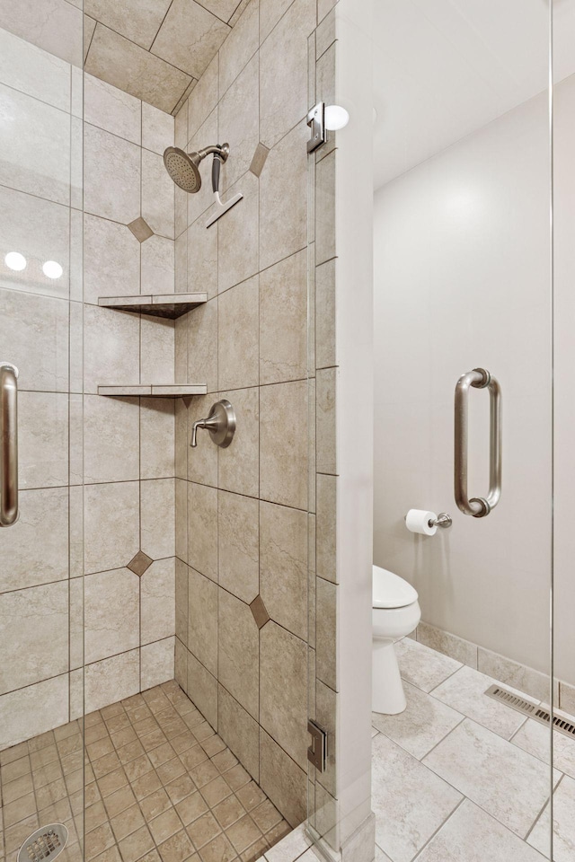 full bathroom featuring tile patterned floors, visible vents, toilet, and a stall shower