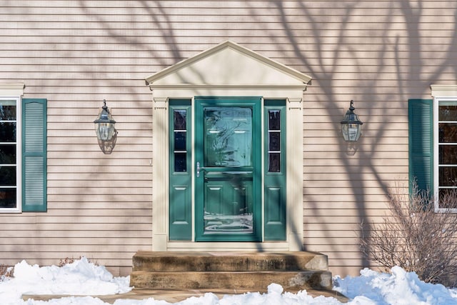 view of snow covered property entrance