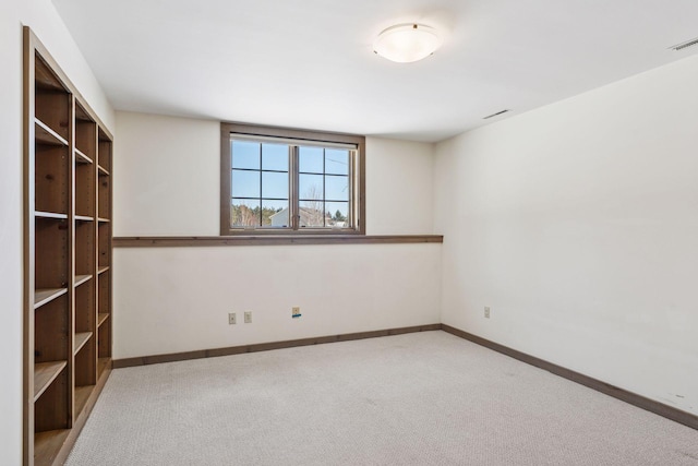 empty room with visible vents, carpet, and baseboards