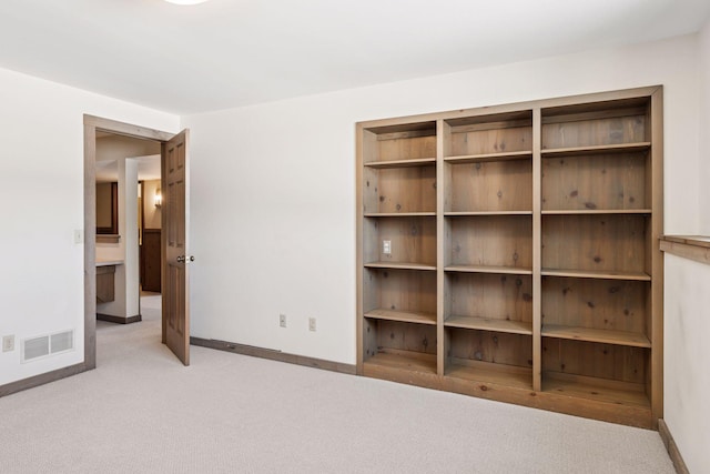 empty room featuring visible vents, baseboards, and carpet