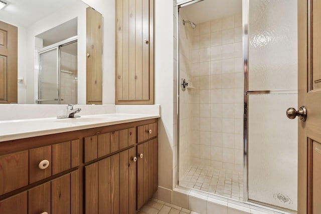 full bathroom featuring visible vents, vanity, and a shower stall