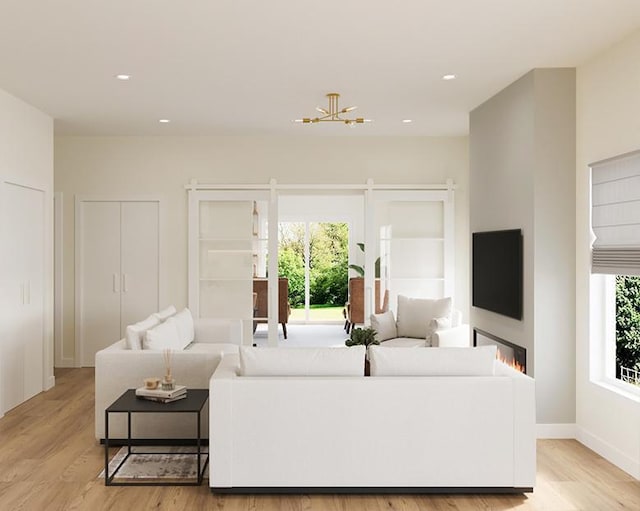 living room featuring baseboards, light wood finished floors, a wealth of natural light, and recessed lighting