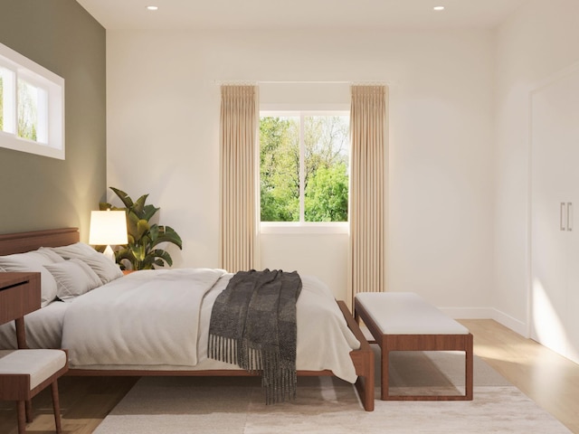 bedroom with recessed lighting and light wood-style floors