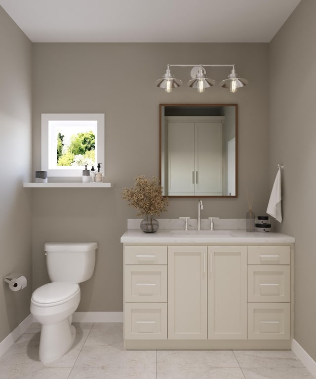 bathroom featuring tile patterned flooring, baseboards, vanity, and toilet