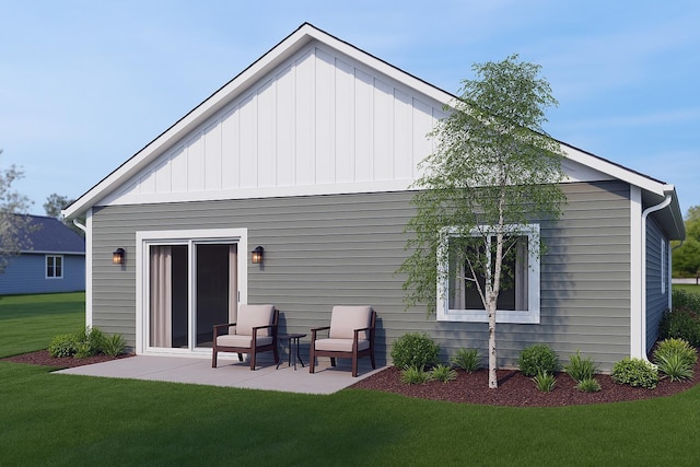 rear view of house with a lawn, board and batten siding, and a patio