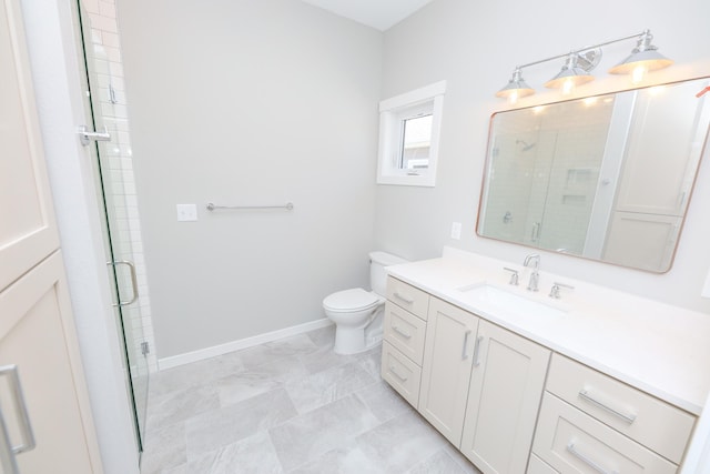 bathroom with vanity, toilet, a stall shower, and baseboards