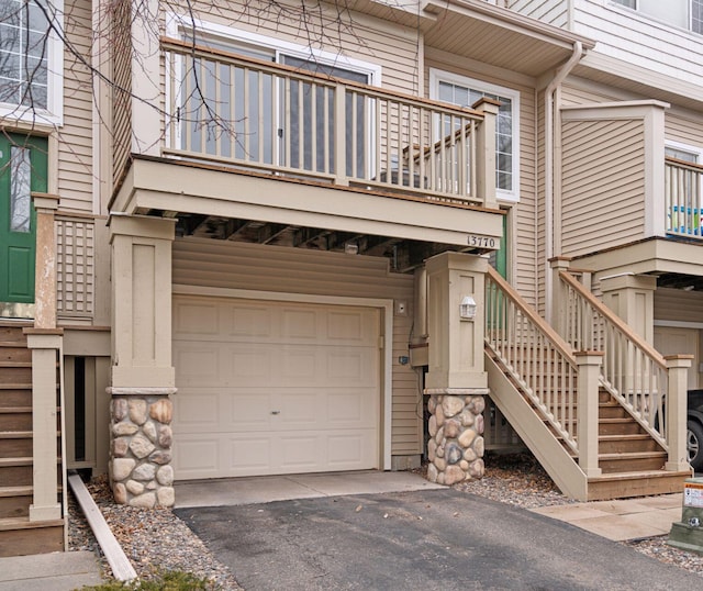 view of front facade with aphalt driveway and a garage